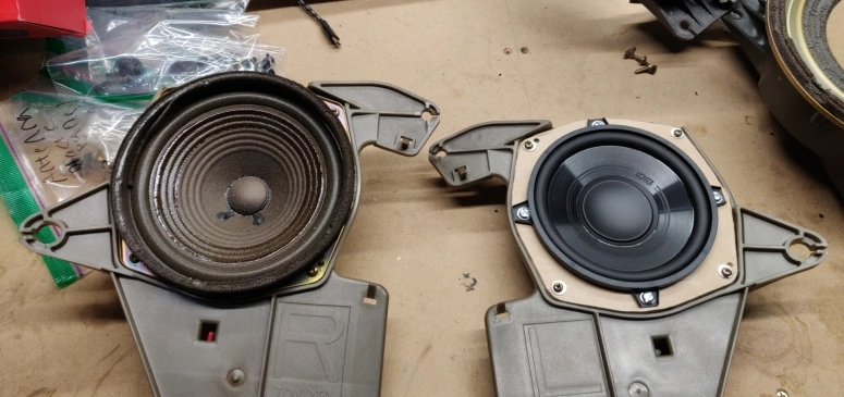 Old oem celica rear speaker next to new Polk audio speaker