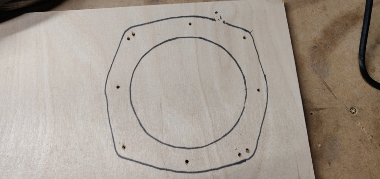 Rear speaker adapter outline on a birch plywood