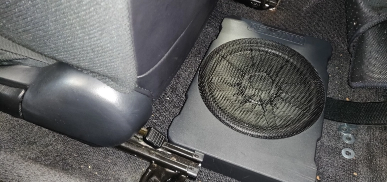 Kicker 46HS10 on floor behind passenger seat