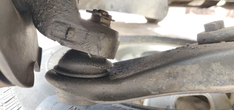 Lower control arm ball joint boot wear