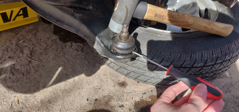 Popping off lower control arm ball joint boot