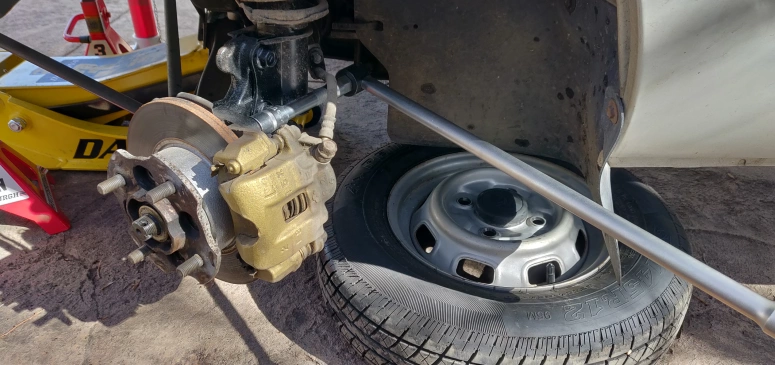 Breaker bar with socket extension on brake caliper bolts