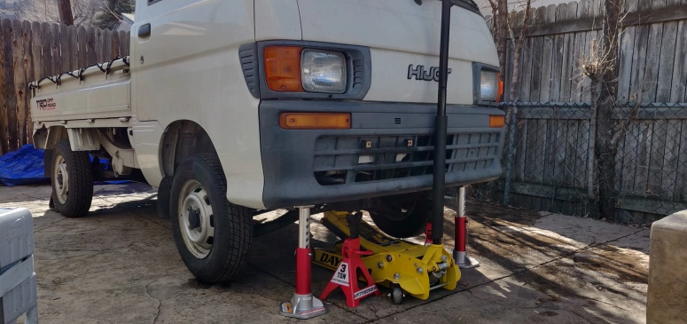 CV axle with new CV boots on a bench